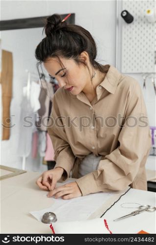fashion designer working her workshop alone 7