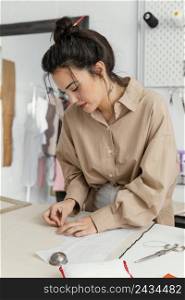 fashion designer working her workshop alone 7