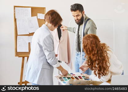 fashion designers working atelier with dress form