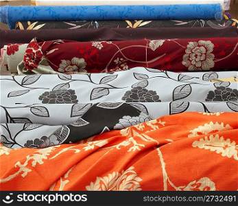 fashion fabric rolls in retail market shop pattern in a row