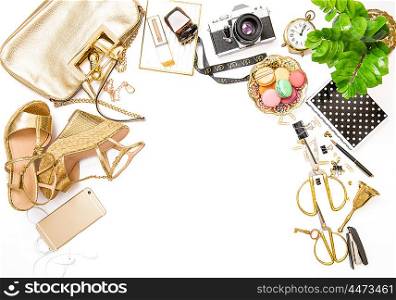 Fashion flat lay for bloggers social media. Feminine golden accessories, bag, shoes, office supplies, vintage no nae photo camera and green plant on white background