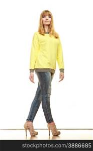 Fashion. Full body blonde fashionable woman jeans pants yellow blouse. Female model posing isolated studio shot