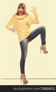 Fashion. Full body fashionable crazy woman jeans pants yellow blouse. Filtered photo