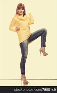 Fashion. Full body serious woman jeans pants yellow blouse. Filtered photo