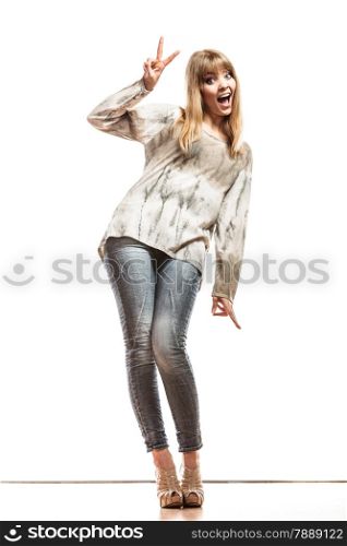 Fashion. Full length happy woman jeans pants showing victory hand sign gesture isolated
