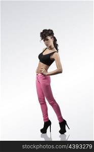 fashion full-length portrait of attractive woman with brown curly hair-style, sexy black top, pink treasure and heels isolated on background