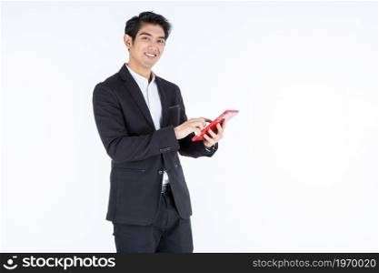 fashion handsome young Asian businessman using a tablet typing message guy isolated on white grey blank copy space studio background,indoor studio shoot