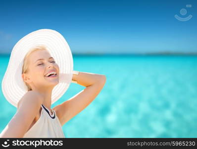 fashion, happiness and lifestyle concept - beautiful woman in hat enjoying summer outdoors