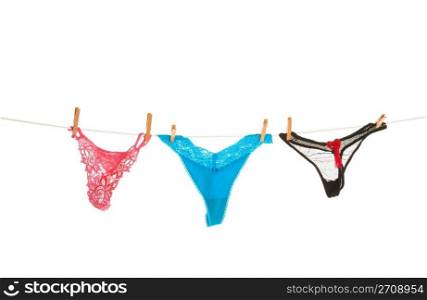 Fashion intimates hung on the clothes line to dry. Shot on white background.