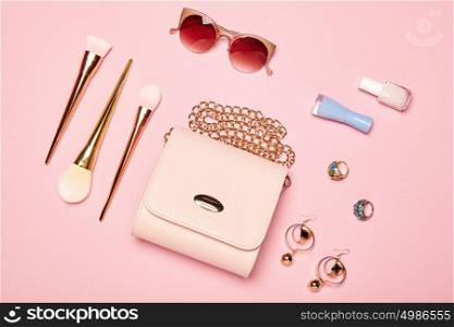 Fashion lady accessories set. Falt Lay. Stylish handbag. Make-Up brushes. Summer sunglasses. Jewelry and nail polish. Women accessories. Trendy fashion design