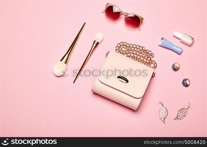 Fashion lady accessories set. Falt Lay. Stylish handbag. Make-Up brushes. Summer sunglasses. Jewelry and nail polish. Women accessories. Trendy fashion design