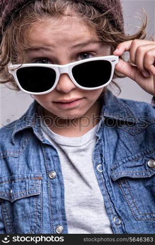 Fashion little boy wearing trendy white sunglasses