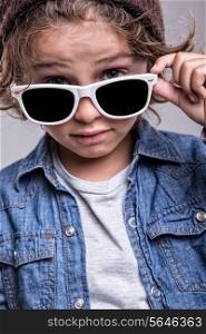 Fashion little boy wearing trendy white sunglasses