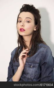 Fashion looks. Young model posing in denim shirt.