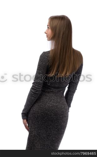 Fashion luxury portrait of young girl in gray style dress with long healthy glossy brown hairs posing back side. On white background in studio isolated closeup.