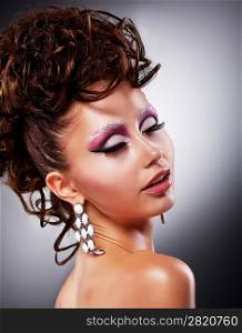 Fashion model - beauty girl portrait. Bright holiday makeup an coiffure