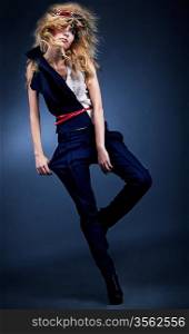 Fashion model girl posing in blue leggings - studio shot