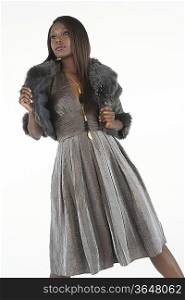 Fashion model in grey dress with fake fur stole