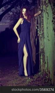 Fashion Model in Modern Blue Dress posing Outdoors