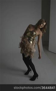 Fashion Model Modeling Gold Dress With Feathers