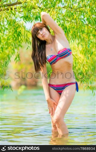 fashion model posing in nature in the pond