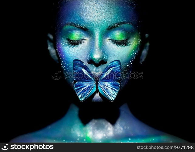 Fashion model woman in bright sparkles and neon lights posing in studio. Portrait of beautiful woman with butterfly. Art design glitter glowing make up