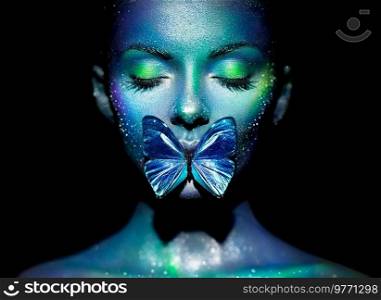 Fashion model woman in bright sparkles and neon lights posing in studio. Portrait of beautiful woman with butterfly. Art design glitter glowing make up