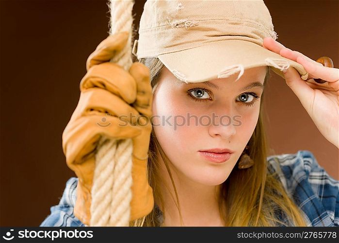 Fashion model - young woman country style posing with rope