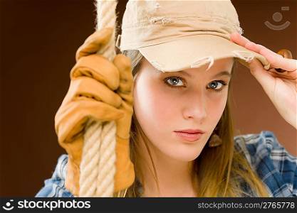 Fashion model - young woman country style posing with rope