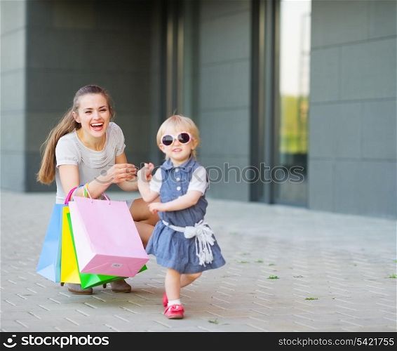 Fashion-monger baby on shopping with mom wear new glasses