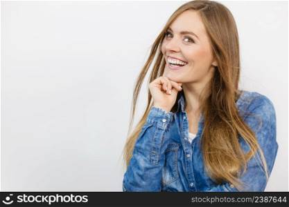 Fashion, people, jeans concept. Beautiful girl is smiling. Young woman is wearing denim shirt. . Cheerful young lady is smiling.