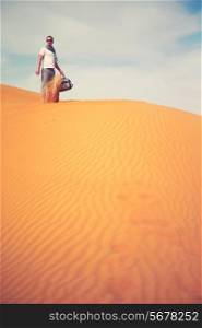 Fashion photo man standing in the desert