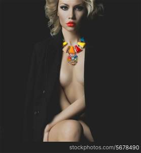Fashion photo of a beautiful blonde with bright makeup and jewelry