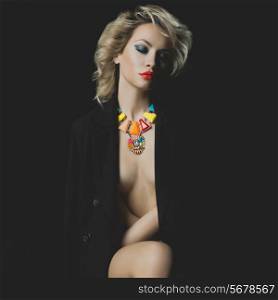 Fashion photo of a beautiful blonde with bright makeup and jewelry