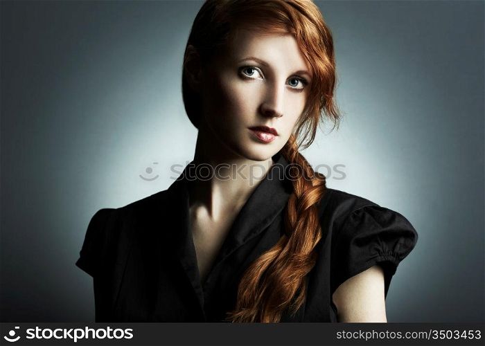 Fashion photo of a beautiful young red-haired woman