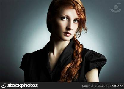 Fashion photo of a beautiful young red-haired woman. Close-up portrait