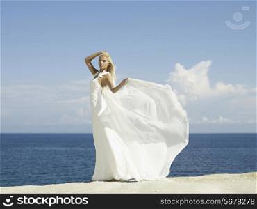 Fashion photo of beautiful elegant bride at the seashore