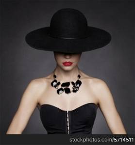 Fashion photo of beautiful lady in elegant black hat