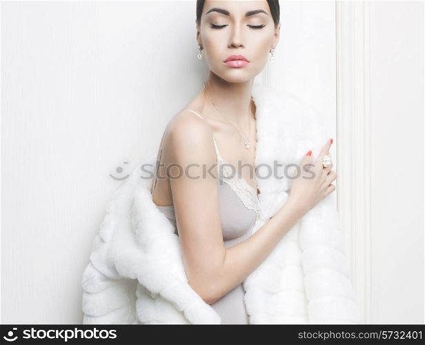 Fashion photo of beautiful lady in elegant white fur coat