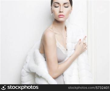 Fashion photo of beautiful lady in elegant white fur coat