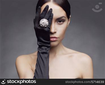 Fashion photo of beautiful lady in gloves with diamond ring
