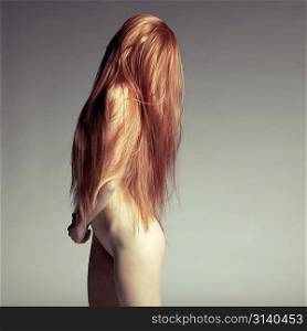 Fashion photo of beautiful nude woman with magnificent hair