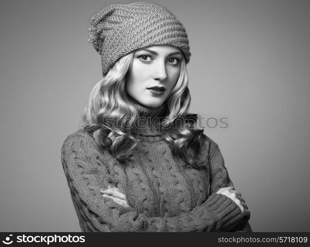 Fashion photo of beautiful woman in sweater. Curly hairstyle. Make-up. Black and white