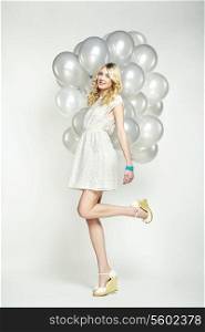 Fashion photo of beautiful woman with balloons. Girl posing. Studio photo