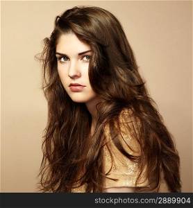Fashion photo of beautiful woman with magnificent hair. Studio portrait