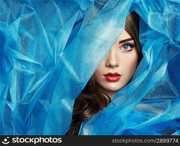 Fashion photo of beautiful women under blue veil. Beauty portrait