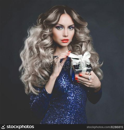 Fashion photo of luxury blonde with a gift