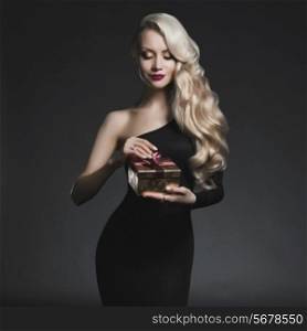 Fashion photo of luxury blonde with Christmas gift