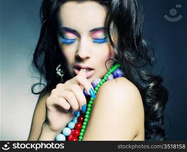 Fashion photo of young beautiful girl with bright beads