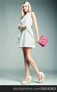 Fashion photo of young magnificent woman. Girl with handbag. Girl posing